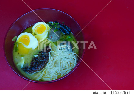 A steaming bowl of ramen with thin wheat noodles. A steaming bowl of ramen with thin wheat noodles. 115522651