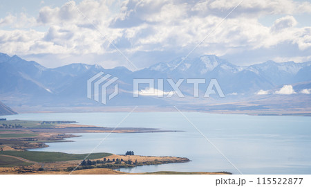 New Zealand landscape scenery with turquoise alpine lake and snowy mountain ranges in backdrop  115522877