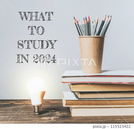 A stack of books and a pencil holde A stack of books and a pencil holde 115523422
