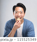 スナック菓子を食べる男性 115525349