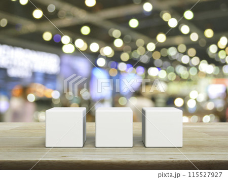 Three white block cubes on wooden table Three white block cubes on wooden table 115527927