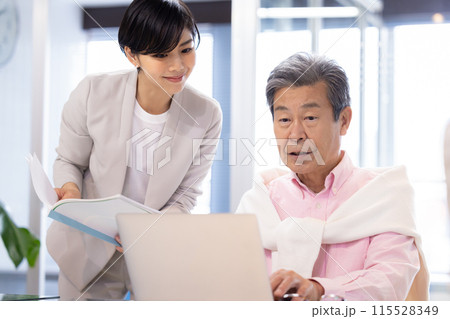 シェアオフィスで仕事をするシニア男性 115528349