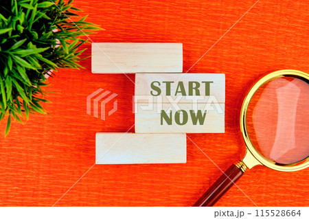 Concept words Success Starts Now. Psychological social and Success Starts Now concept written on wooden blocks with a flower and a magnifying glass in the composition . Beautiful orange background 115528664