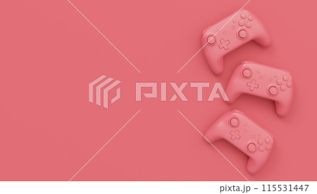 Video game joysticks or gamepads in plain monochrome pink color background 115531447