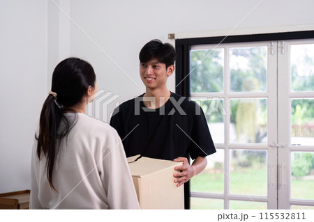 Young Couple Moving into New House, Unpacking Boxes, and Starting a New Chapter Together in Their Modern Home Young Couple Moving into New House, Unpacking Boxes, and Starting a New Chapter Together in Their Modern Home 115532811