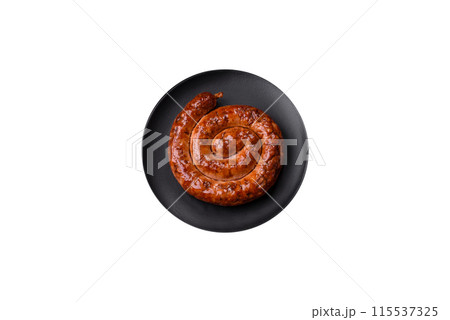 Delicious homemade sausage in the form of a spiral baked on the grill with salt, spices Delicious homemade sausage in the form of a spiral baked on the grill with salt, spices 115537325