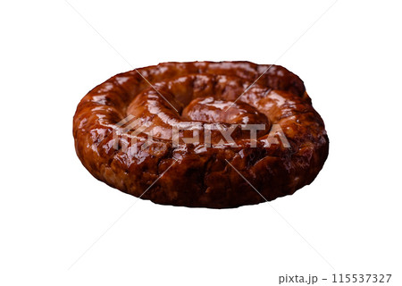 Delicious homemade sausage in the form of a spiral baked on the grill with salt, spices 115537327