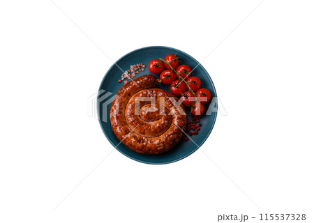 Delicious homemade sausage in the form of a spiral baked on the grill with salt, spices Delicious homemade sausage in the form of a spiral baked on the grill with salt, spices 115537328