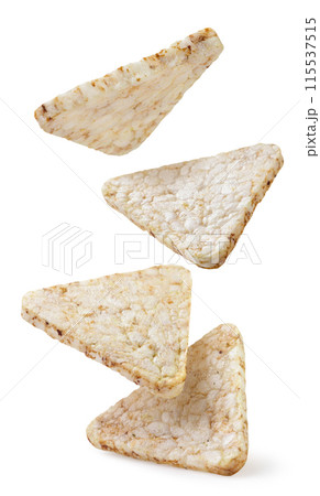 Rice crisps triangles falling on white background. Isolated 115537515