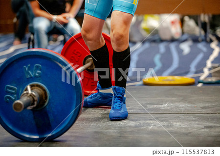 legs woman athlete in black knee socks near barbell deadlift legs woman athlete in black knee socks near barbell deadlift 115537813