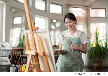 Talented Artist Painting in Bright Workshop. Creative Process in Modern Art Studio with Natural Light and Artistic Tools 115538183