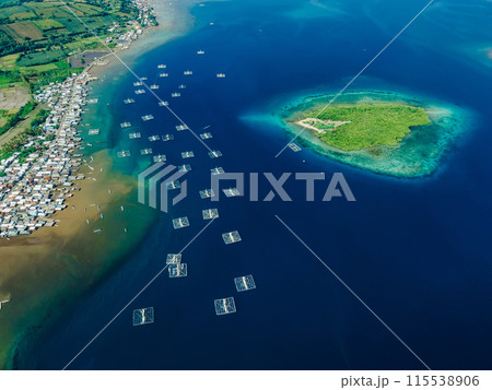 Indonesian village and fishing boats in ocean on Sumbawa island. Scenic drone view. Indonesian village and fishing boats in ocean on Sumbawa island. Scenic drone view. 115538906