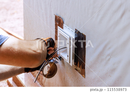 Weatherproof deep plastic electrical box is mounted on outside wall Weatherproof deep plastic electrical box is mounted on outside wall 115538973