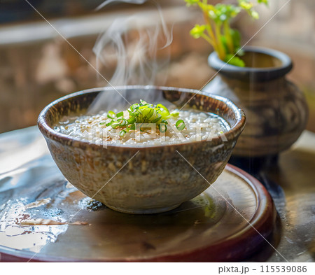 Steam of Mush or boiled rice asian style with smoke in wood bowl on dark background.1 115539086