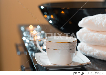 Burning candles and pile of towels Burning candles and pile of towels 115539437