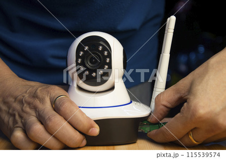 Conceptual man operating ip camera Conceptual man operating ip camera 115539574