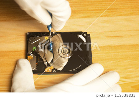 Top view of mechanic repairing hard drive Top view of mechanic repairing hard drive 115539833