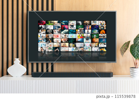 Man watching TV with remote control in hand. 115539878