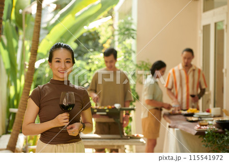 Woman Attending Barbeque Party 115541972
