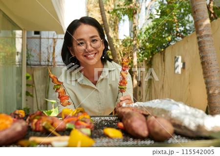 Woman Posing with Cooked Kebabs Woman Posing with Cooked Kebabs 115542005