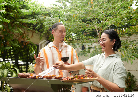 Couple Grilling Meat and Veggies Couple Grilling Meat and Veggies 115542114