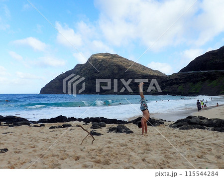 Man Handstands on Makapuu beach Man Handstands on Makapuu beach 115544284