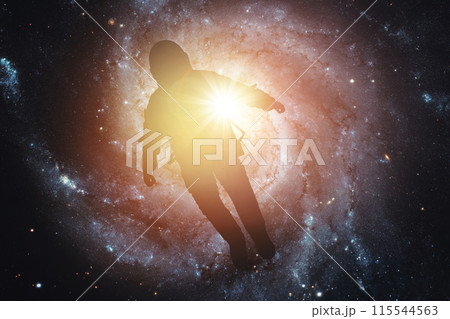 Silhouette of an astronaut in space against the background of the galaxy. Elements of this image furnished by NASA 115544563