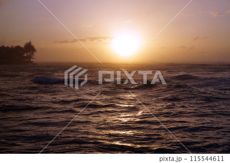 Sunset over the ocean with waves moving to shore Sunset over the ocean with waves moving to shore 115544611