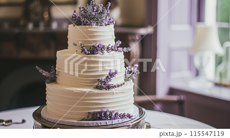 Wedding cake with lavender flowers. Festive table decoration. 115547119