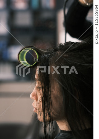 Hair stylist working in a salon. Blurred image for background Hair stylist working in a salon. Blurred image for background 115555964