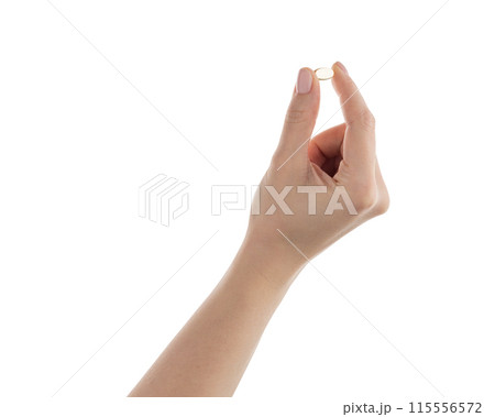Female hand hold transparent pill isolated on white 115556572