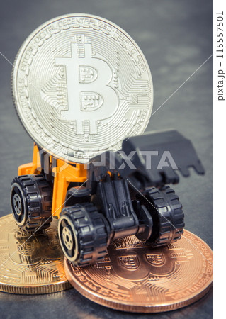 Bitcoins and miniature excavator. Cryptocurrency and international network payment. Finance concept Bitcoins and miniature excavator. Cryptocurrency and international network payment. Finance concept 115557501