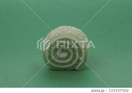 Green gelatin candy on a background of the same color. Green gelatin candy on a background of the same color. 115557502
