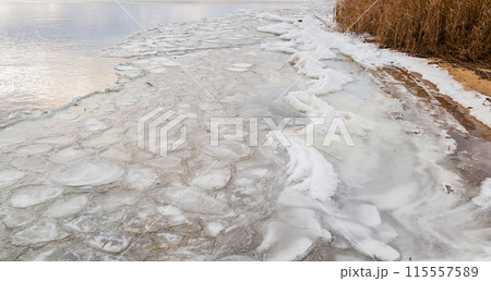 The surface of a freezing lake in autumn in bad weather. The surface of a freezing lake in autumn in bad weather. 115557589