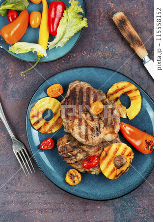 Pork steak with pineapple on plate. 115558152