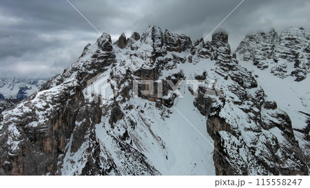 Rocky snow mountains and clouds 115558247