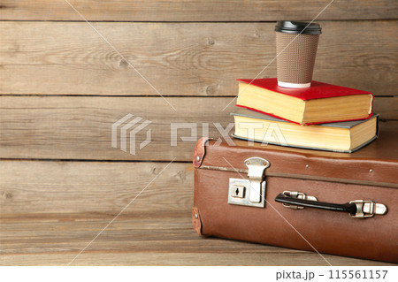 Old suitcase and books with cup of coffee 115561157