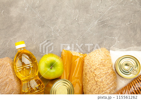 Food donations for people. Donation food on the grey background. Top view. Food donations for people. Donation food on the grey background. Top view. 115561262