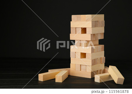 Blocks of wood on black background. Tower Blocks of wood on black background. Tower 115561878