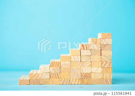 Blocks of wood on blue background. Tower Blocks of wood on blue background. Tower 115561941