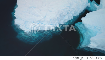 Underwater ice, snow covered iceberg floating polar ocean close up. Massive nature icy formations aerial in shot. Natural beauty of towering glacier melting due to global warming, climate change 115563397