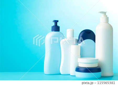 Different cosmetic bottles on blue background with copy space. Top view 115565381