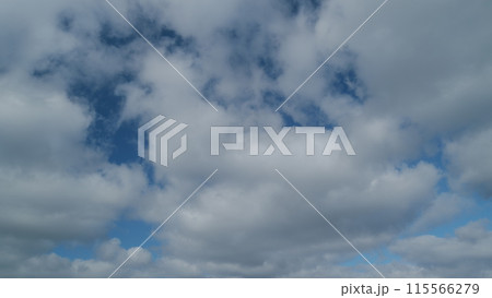 Fluffy curly rolling clouds in windy weather. Sun rays throughcloud on blue sky. Timelapse. Fluffy curly rolling clouds in windy weather. Sun rays throughcloud on blue sky. Timelapse. 115566279