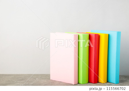 Multi coloured school books on a white background with copy space. 115566702