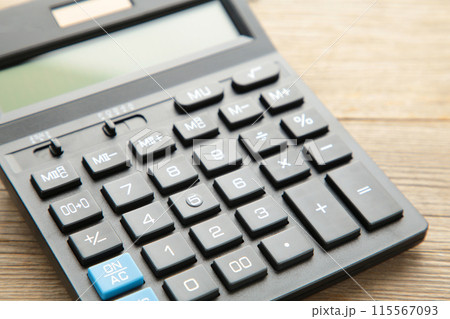 Calculator on grey wooden background, macro foto Calculator on grey wooden background, macro foto 115567093