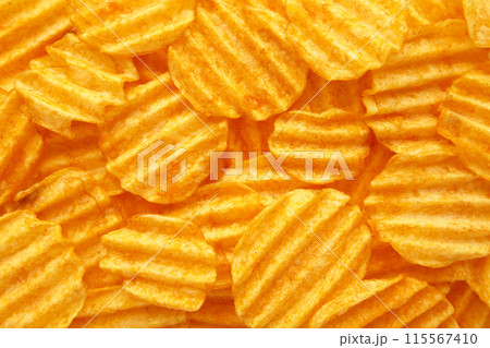 Rippled golden potato chips background with copy space for text Rippled golden potato chips background with copy space for text 115567410