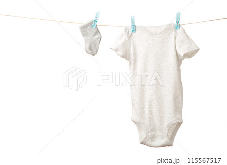 Baby clothes hanging on the clothesline isolated on white. 115567517