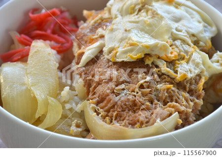deep fried slice pork with egg or tonkatsu with Japanese pickled vegetable on rice in bowl deep fried slice pork with egg or tonkatsu with Japanese pickled vegetable on rice in bowl 115567900