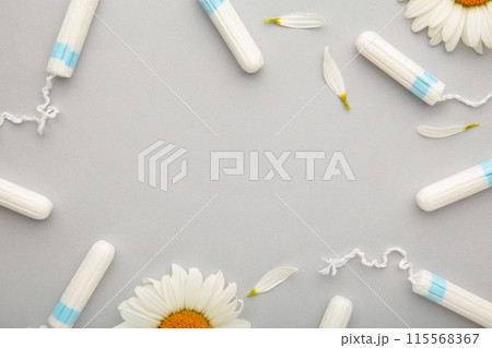 Medicinal chamomile flower and menstrual sanitary tampon. Woman critical days, gynecological menstruation cycle. 115568367