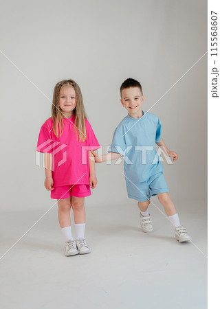 Little couple kids boy girl 4-5 years old have fun isolated on white background children studio portrait. People childhood lifestyle concept 115568607